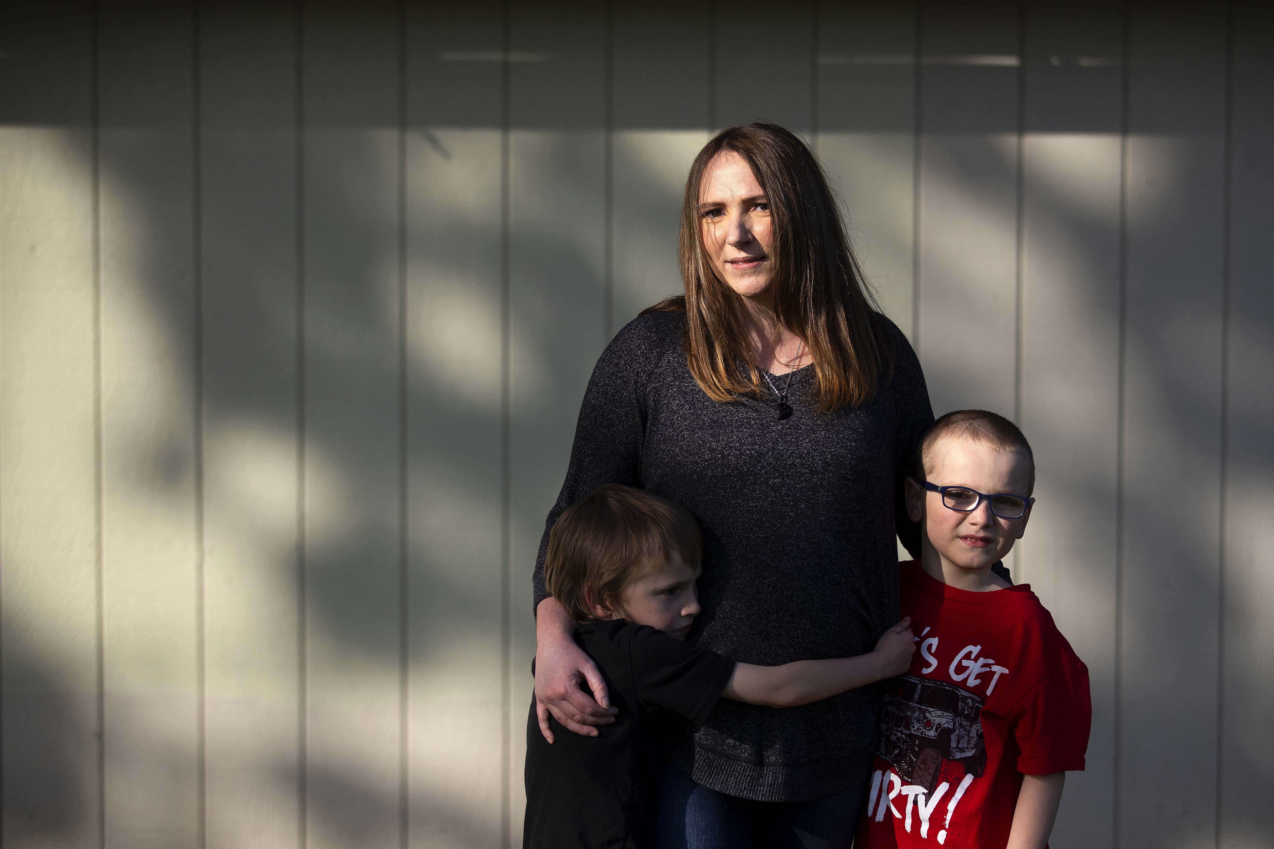 Amanda Schroeder, 31, stands with her two sons Jayden, 6, left, and Jeremiah, 8, on Tuesday, April 25, 2023, at Erickson Park in Port Angeles. KUOW Photo/Megan Farmer.